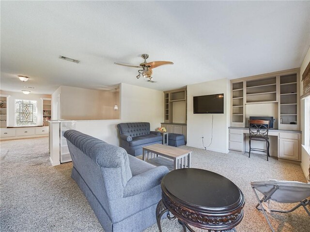 1024 Claire Dr, Slidell, LA 70461 - carpeted living area featuring a ceiling fan, built in shelves, and built in study area