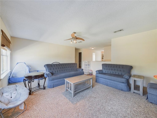 1024 Claire Dr, Slidell, LA 70461 - living room with a textured ceiling, carpet, and ceiling fan