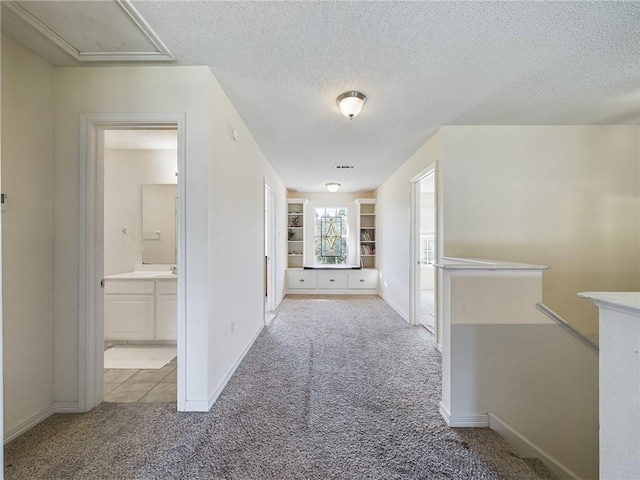 1024 Claire Dr, Slidell, LA 70461 - hallway with carpet floors, an upstairs landing, and a textured ceiling
