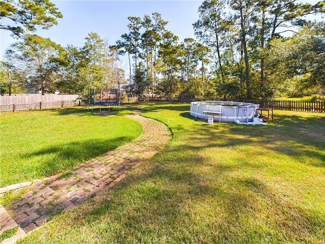 1024 Claire Dr, Slidell, LA 70461 - fenced backyard featuring a trampoline