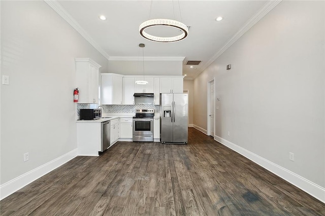 kitchen with stainless steel appliances, dark hardwood / wood-style flooring, crown molding, pendant lighting, and white cabinets