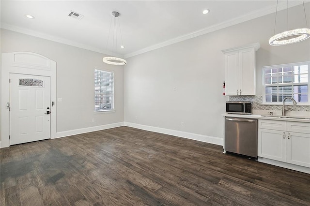 kitchen featuring white cabinetry, dark hardwood / wood-style flooring, sink, and appliances with stainless steel finishes