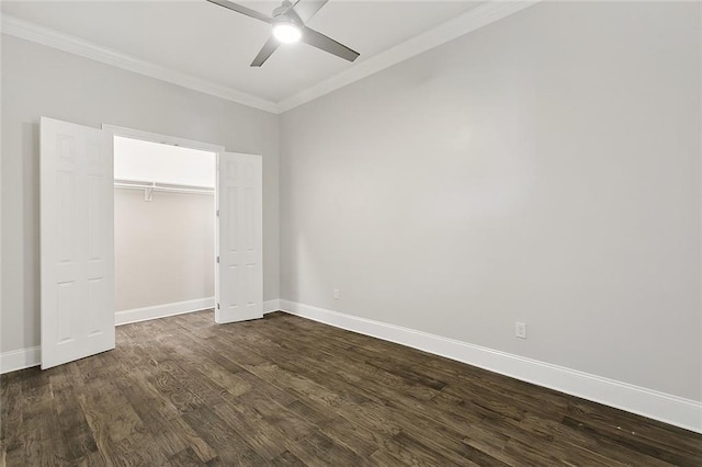 unfurnished bedroom featuring ceiling fan, ornamental molding, dark wood-type flooring, and a closet