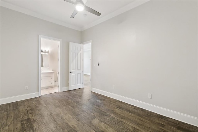 unfurnished bedroom featuring ensuite bathroom, ceiling fan, crown molding, and dark hardwood / wood-style floors