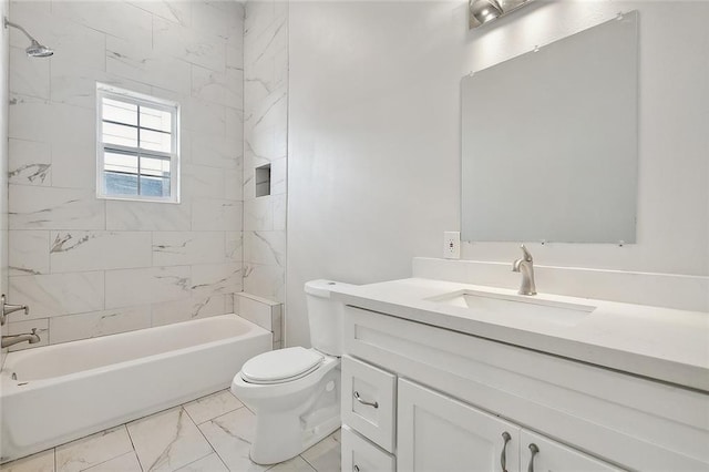 full bathroom featuring tiled shower / bath combo, toilet, and vanity