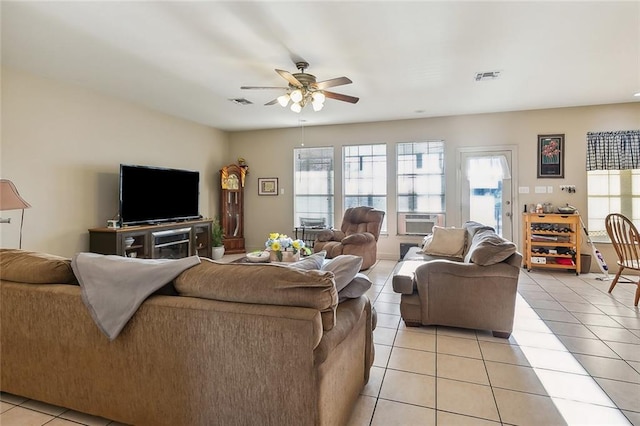 tiled living room featuring ceiling fan and cooling unit