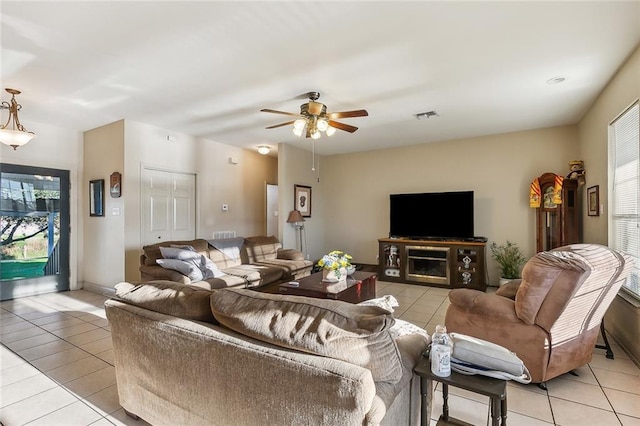 living room with ceiling fan, light tile patterned floors, and a fireplace