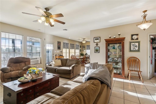 living room featuring cooling unit, ceiling fan, and light tile patterned floors