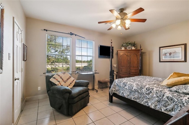 tiled bedroom featuring ceiling fan