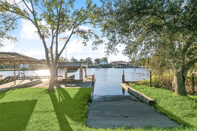 dock area featuring a lawn and a water view