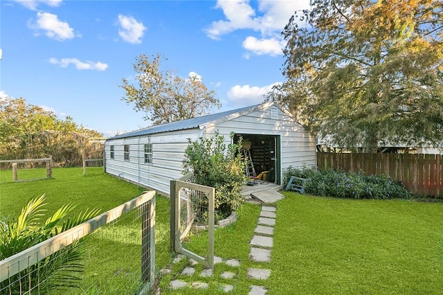 back of property with a yard and an outbuilding