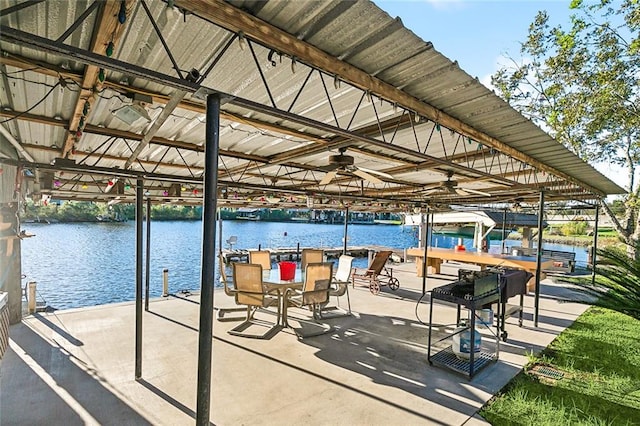 view of patio with ceiling fan and a water view