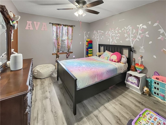 bedroom featuring ceiling fan and light hardwood / wood-style floors