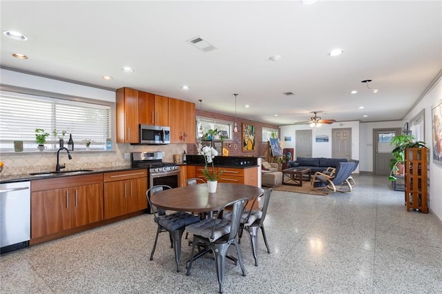 dining room with ceiling fan and sink