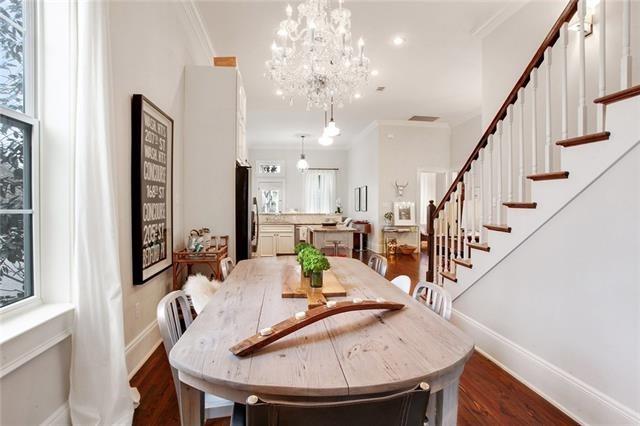 dining space with crown molding, dark wood-type flooring, and a notable chandelier