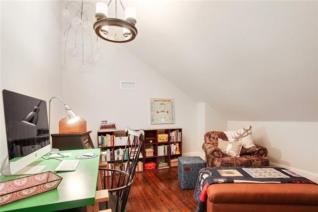 interior space featuring wood-type flooring, lofted ceiling, and a notable chandelier