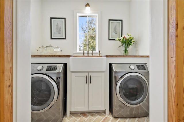 laundry room featuring cabinets, washer / dryer, and sink