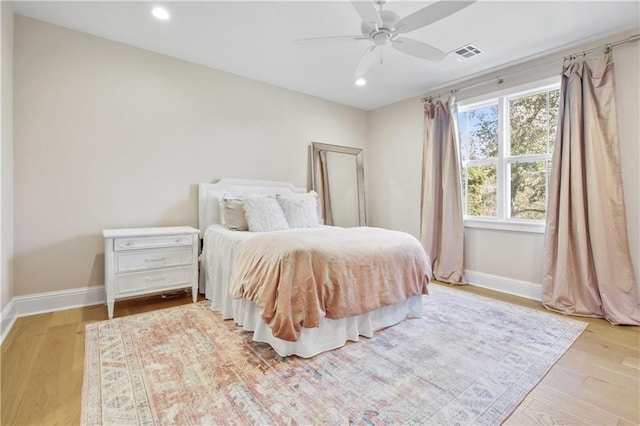 bedroom with ceiling fan and light hardwood / wood-style floors