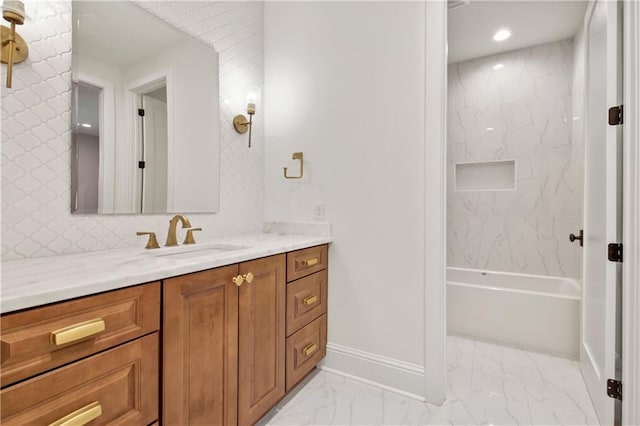 bathroom with vanity and tiled shower / bath