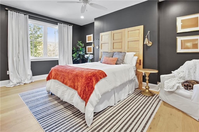 bedroom with hardwood / wood-style floors and ceiling fan