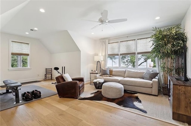 living room with light wood-type flooring, ceiling fan, and lofted ceiling