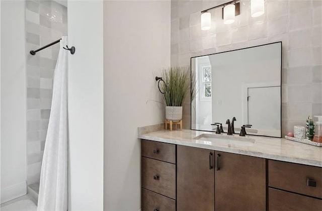 bathroom featuring curtained shower and vanity