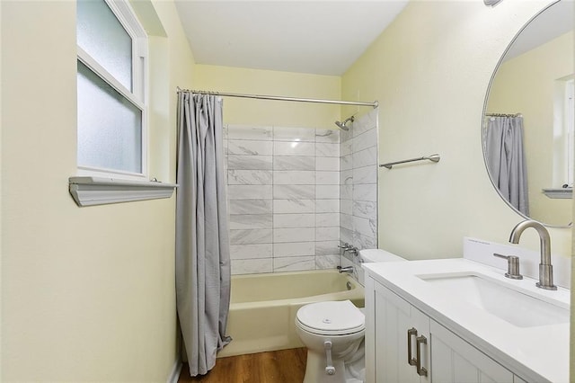 full bathroom featuring vanity, hardwood / wood-style floors, shower / bathtub combination with curtain, and toilet