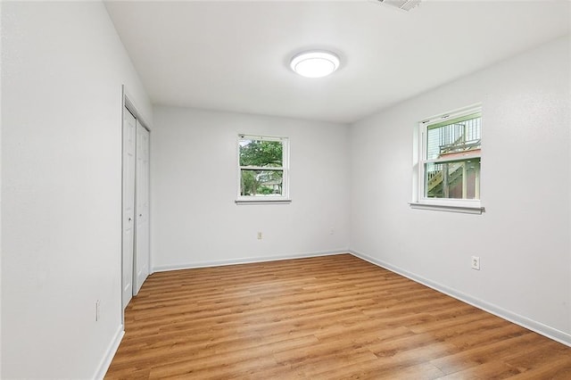 unfurnished bedroom featuring a closet and light hardwood / wood-style flooring