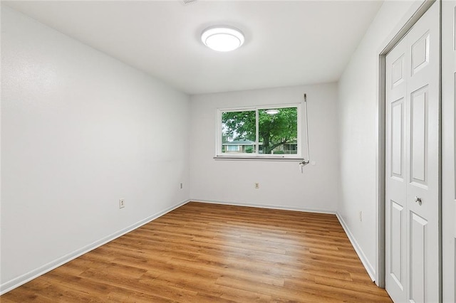 unfurnished bedroom featuring a closet and light hardwood / wood-style floors