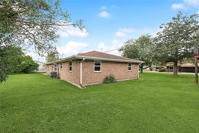 view of property exterior with cooling unit and a lawn