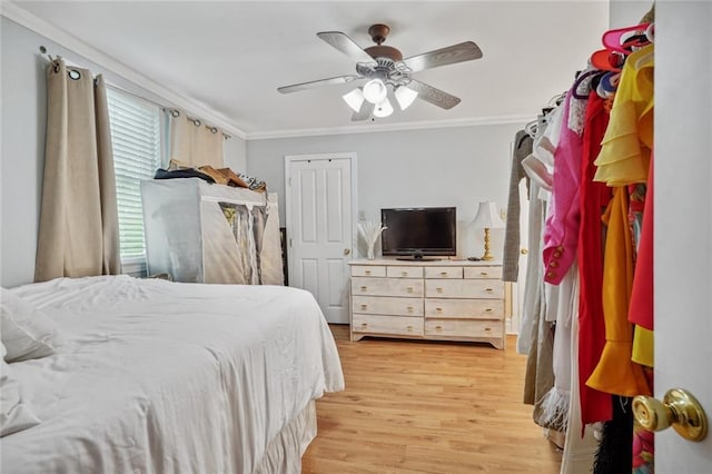 bedroom featuring crown molding, ceiling fan, and light hardwood / wood-style floors