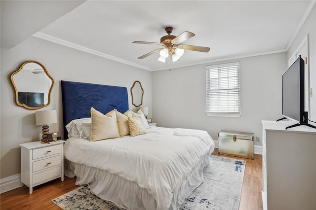 bedroom with crown molding, ceiling fan, and light hardwood / wood-style floors