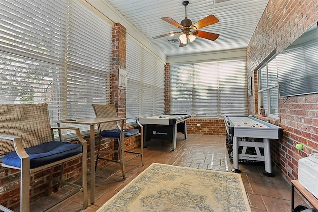 sunroom with ceiling fan