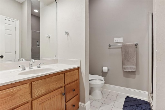 bathroom with tile patterned flooring, vanity, toilet, and an enclosed shower