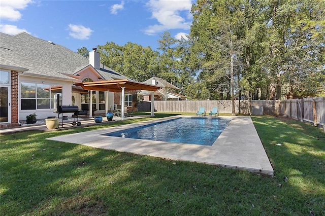 view of pool featuring grilling area, a patio area, and a lawn