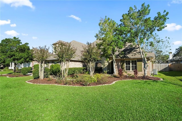 view of front of house featuring a front yard and central AC unit