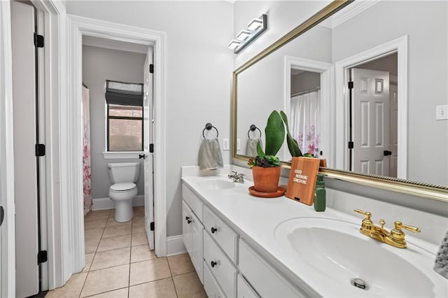 bathroom with tile patterned flooring, vanity, and toilet