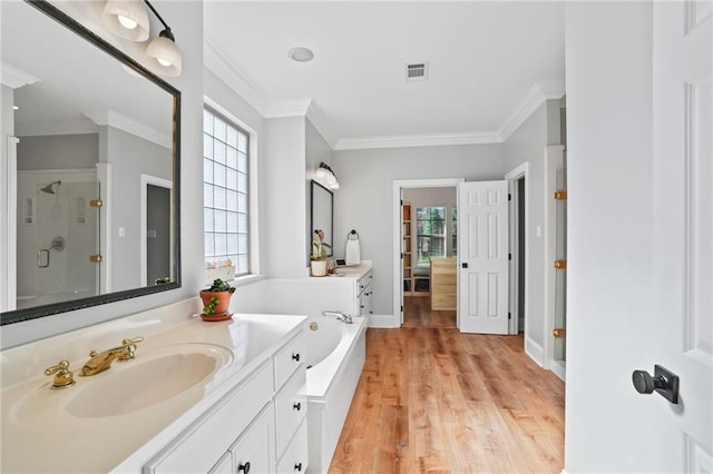 bathroom with separate shower and tub, crown molding, vanity, and hardwood / wood-style flooring