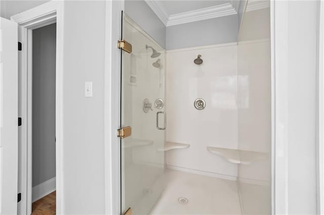 bathroom with ornamental molding and walk in shower