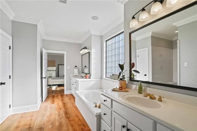 bathroom featuring hardwood / wood-style floors, vanity, and ornamental molding