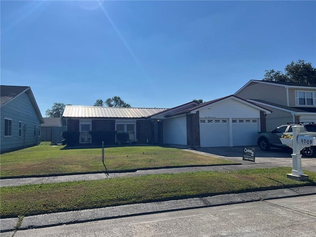 single story home with a garage and a front lawn