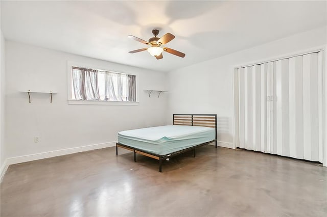 bedroom featuring ceiling fan and concrete flooring