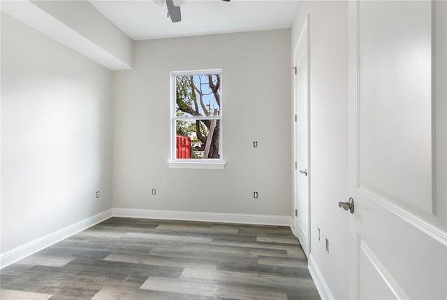 spare room with dark hardwood / wood-style floors and ceiling fan