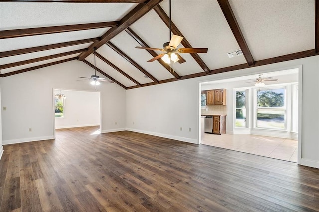 unfurnished living room featuring a textured ceiling, vaulted ceiling with beams, and dark wood-type flooring