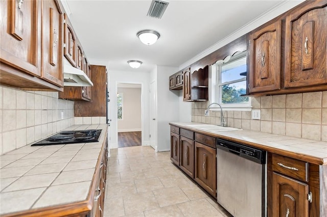 kitchen featuring tasteful backsplash, tile countertops, sink, and stainless steel dishwasher