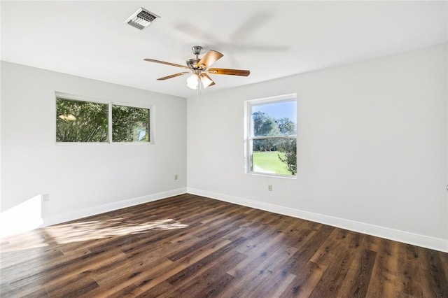 empty room featuring ceiling fan and dark wood-type flooring