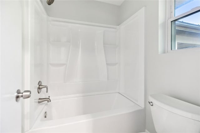 bathroom with shower / bathtub combination and toilet