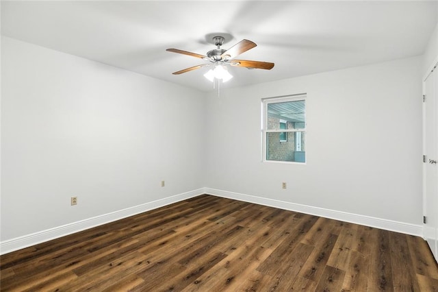 empty room with ceiling fan and dark hardwood / wood-style floors