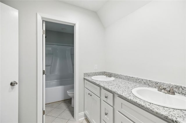 full bathroom featuring vanity, bathing tub / shower combination, vaulted ceiling, tile patterned flooring, and toilet