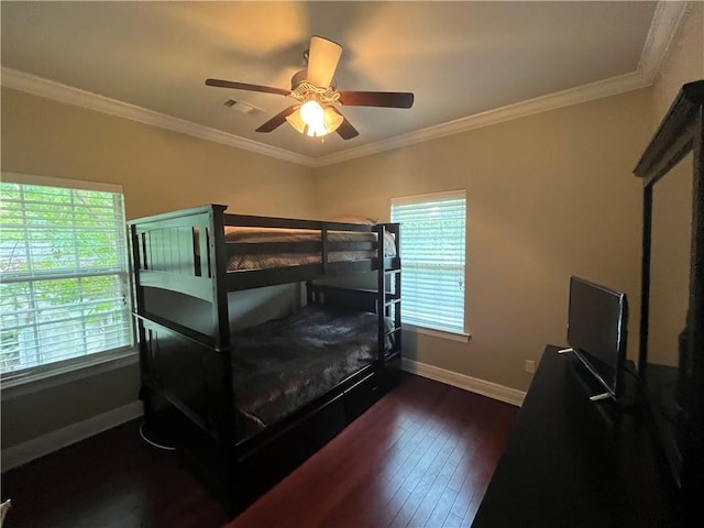 bedroom featuring dark hardwood / wood-style floors, multiple windows, crown molding, and ceiling fan